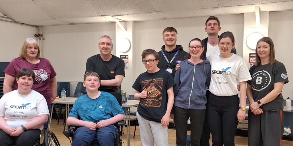 A group of people wearing sportwear. They are smiling
