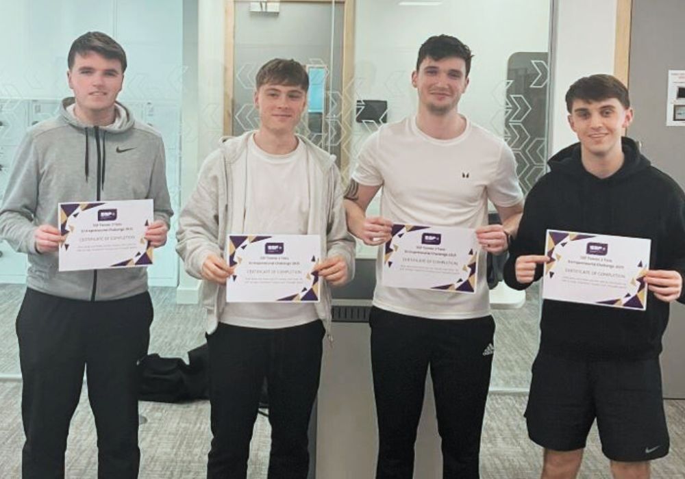 A group of young men holding certificates
