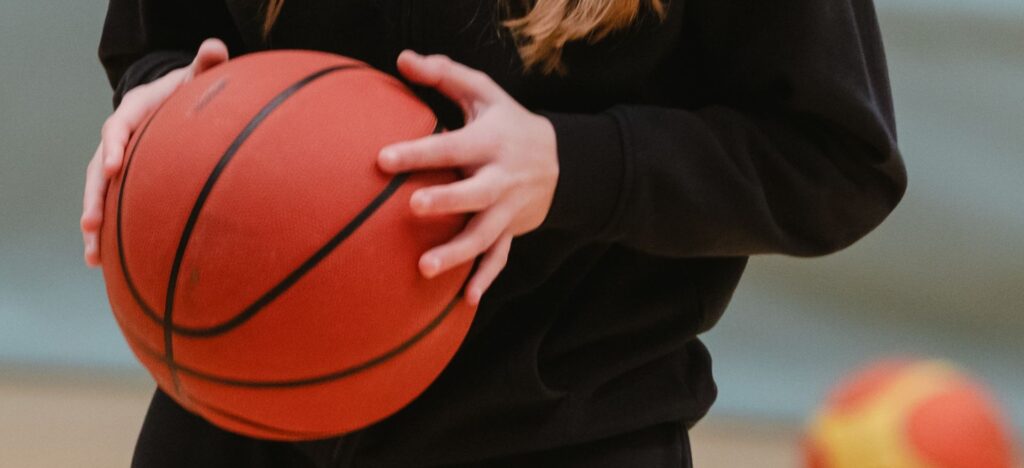 Hands holding a basketball